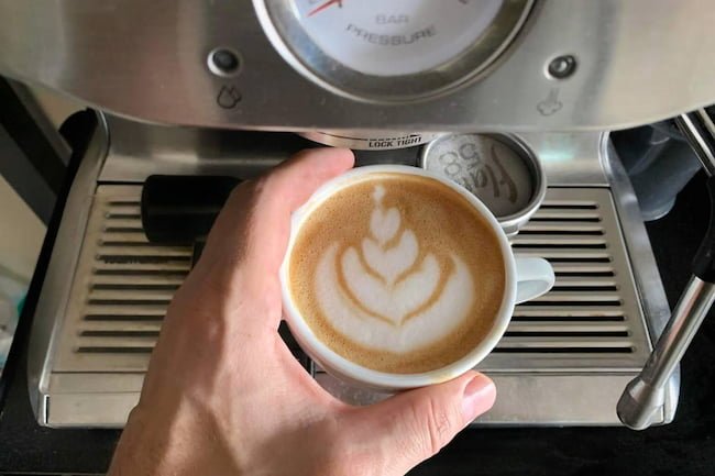 latte art next to breville / sage dual boiler espresso machine