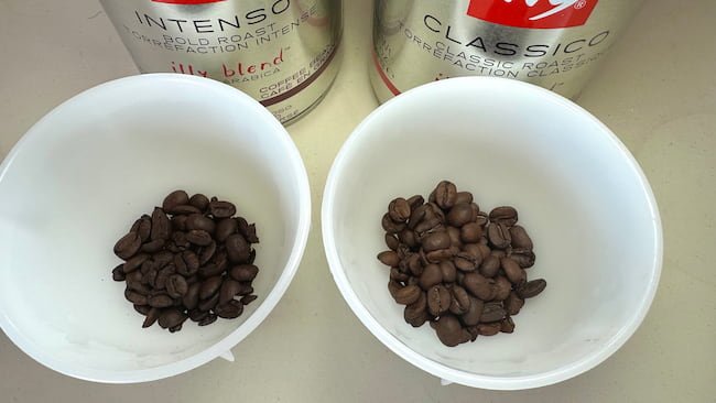 Illy intenso and classico beans next to each other in cupping bowls