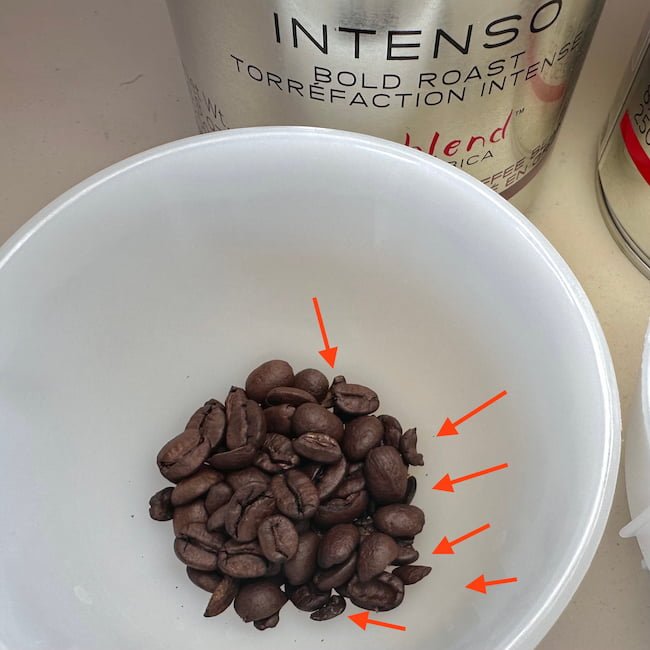 broken illy intenso beans in cupping bowl 