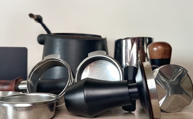 espresso tools and accessories on a table with a white background